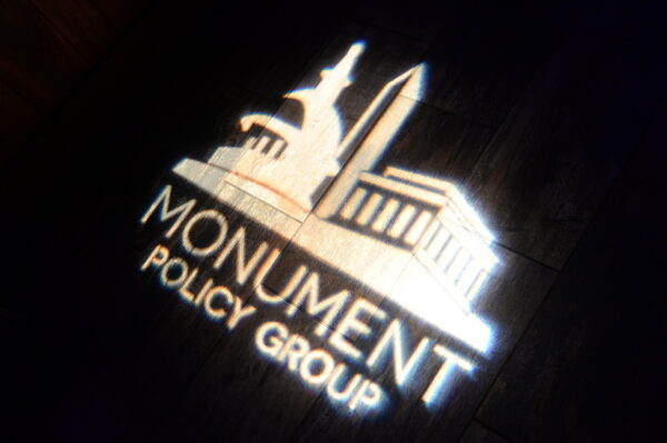 Monument Policy Group Logo at 10 Year Anniversary Party
